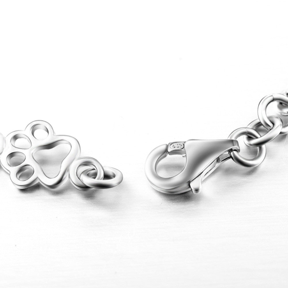 Pulsera con dijes de pata de perro y hueso en plata