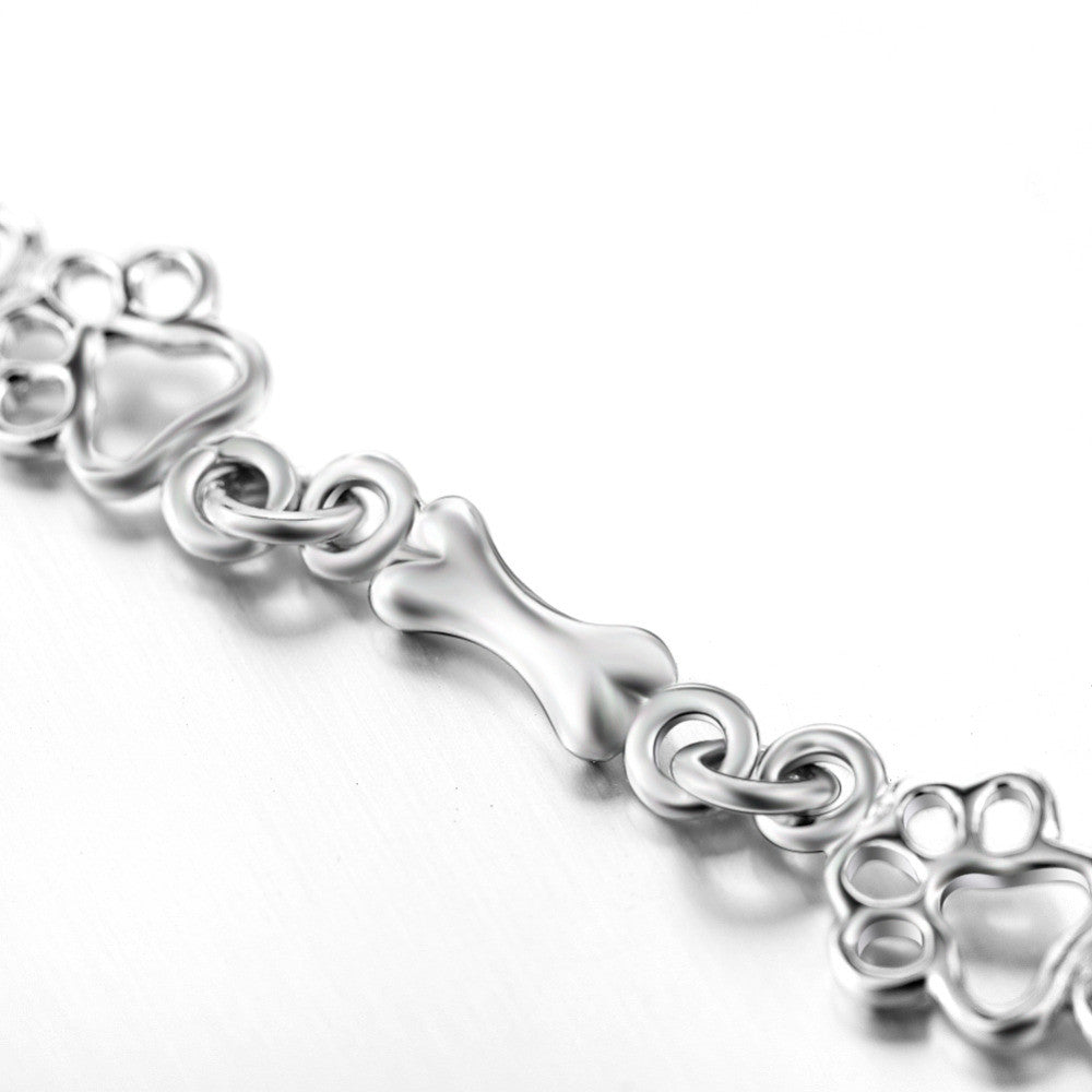 Pulsera con dijes de pata de perro y hueso en plata