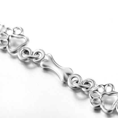Pulsera con dijes de pata de perro y hueso en plata