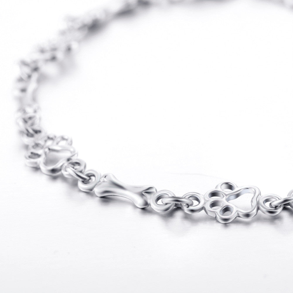 Pulsera con dijes de pata de perro y hueso en plata