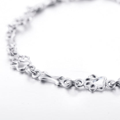 Pulsera con dijes de pata de perro y hueso en plata
