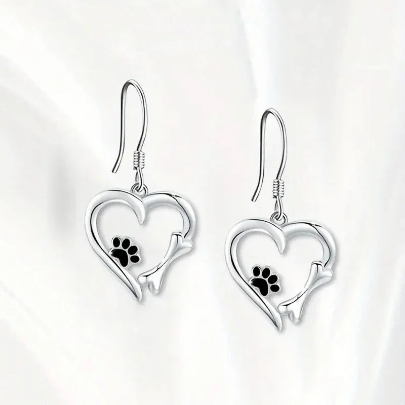 Pendientes colgantes de plata con diseño de corazón y huella de pata.